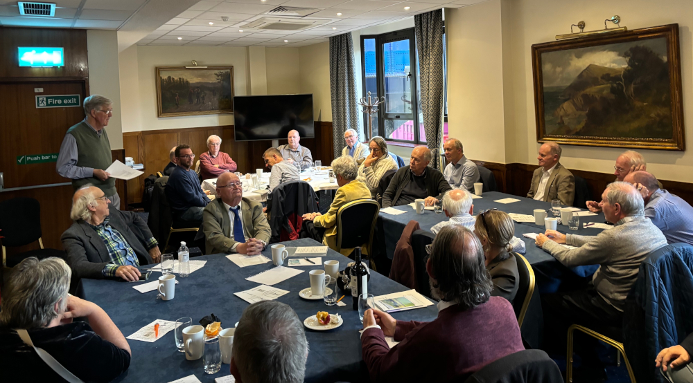 ACS members sitting around tables at the Union Jack Club, listening to Jo Rice speak